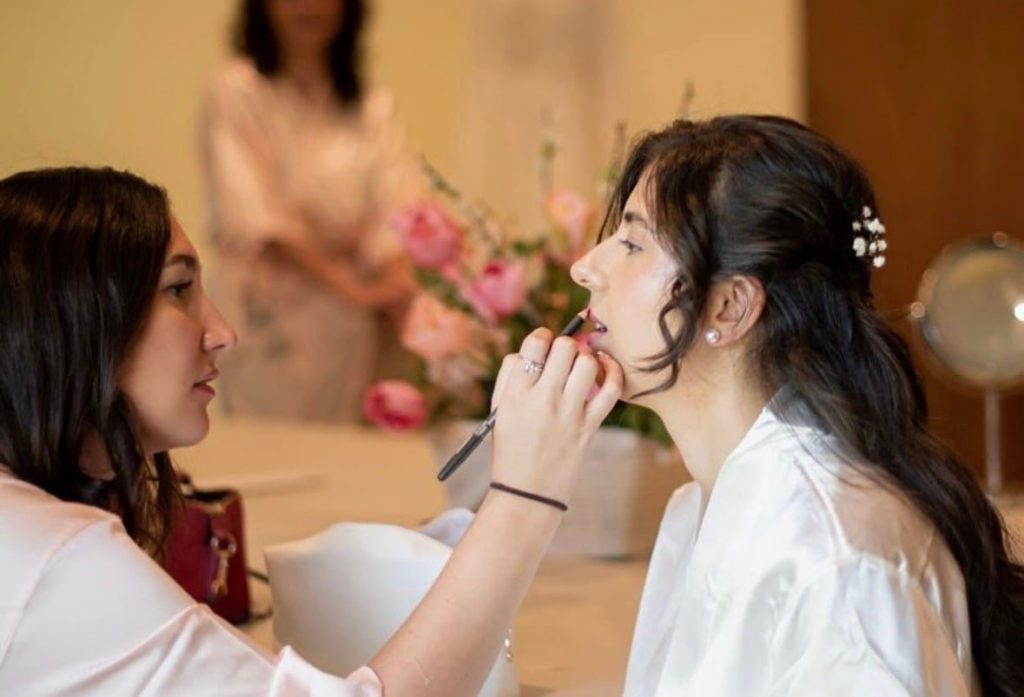 Taylor applying bridal makeup