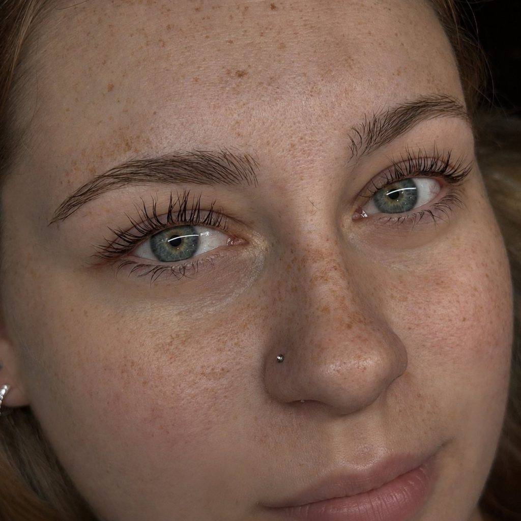 Close-up of lifted, natural-looking lashes on blue eyes